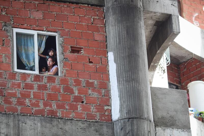 People inside the Tower of David, an abandoned skyscraper in Caracas that became a 'vertical slum'. The government of Venezuela began evicting  the tower's residents last July, relocating hundreds of families that were illegally occupying the building.  Federico Parria / AFP