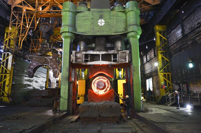 A forgeman oversees the manipulation of a 100 tonne cylinder of freshly cast hot steel. Oli Scarff / AFP