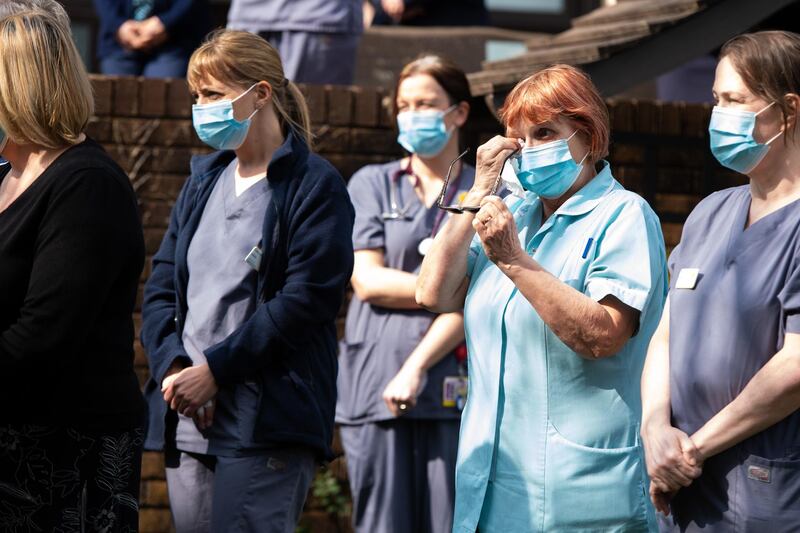 Staff of a Marie Curie hospice take part in a minutes silence in Penarth, Wales. Getty Images