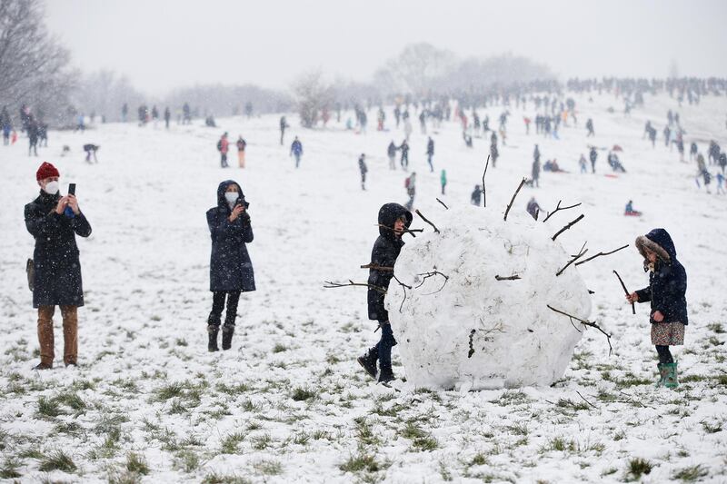 A giant snowball shaped as a coronavirus is seen on Parliament Hill on Hampstead Heath in London, United Kingdom. Parts of the country saw snow and icy conditions as arctic air caused temperatures to drop. Getty Images