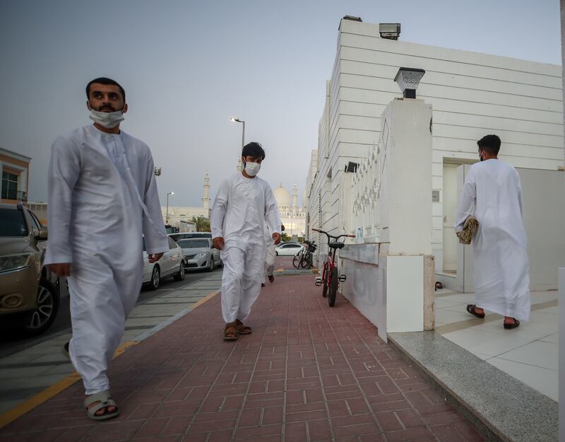 Worshippers in Abu Dhabi make their way to Ibn Taymiyyah Mosque for evening prayers on the day the death of President Sheikh Khalifa was announced. Victor Besa / The National.