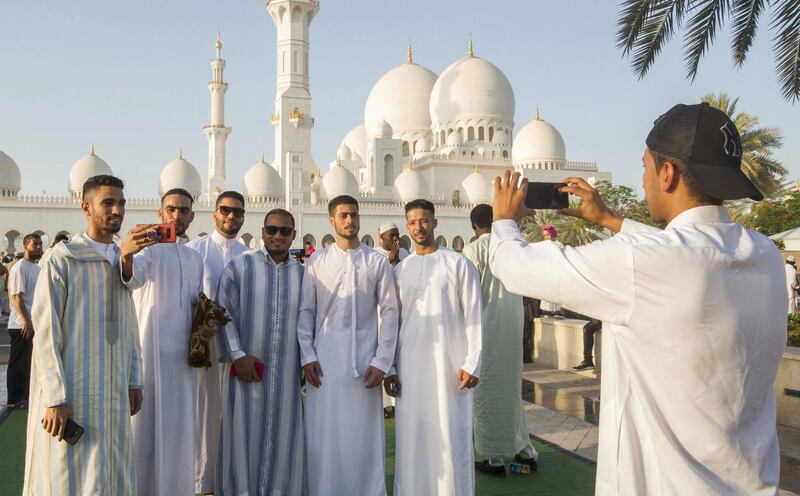 Abu Dhabi, UNITED ARAB EMIRATES -Group photo opportunity after performing morning prayers on the first day of Eid-Al Fitr at the Sheikh Zayed Grand Mosque.  Leslie Pableo for The National