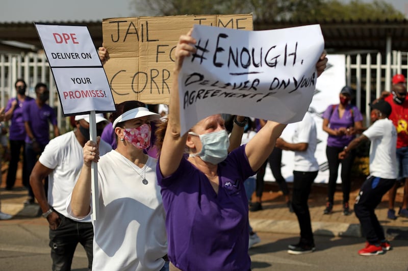 Workers hold placards as they protest outside the headquarters of South African Airways in Johannesburg, South Africa, September 18, 2020. REUTERS/Siphiwe Sibeko