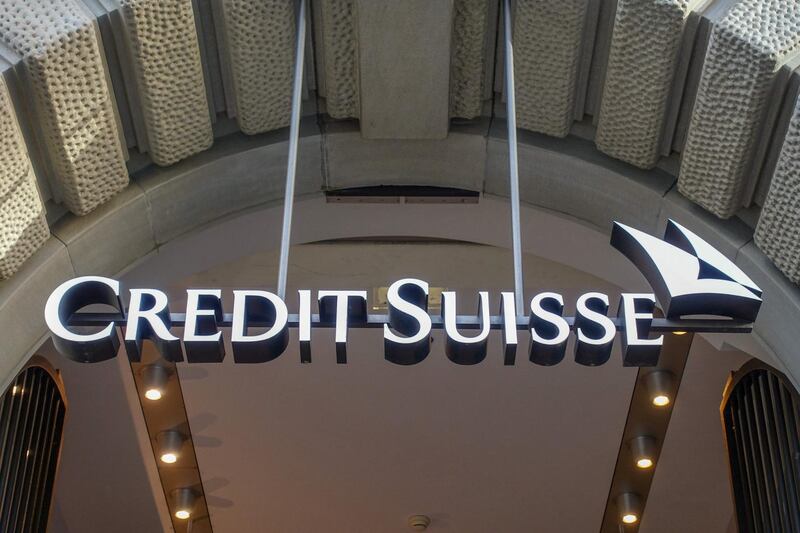 An illuminated sign hangs above an entrance to the Credit Suisse Group AG headquarters in Zurich, Switzerland, on Sunday, Sept 29, 2019. Credit Suisse is seeking to draw a line under one of the worst scandals in its recent history after the bank hired a private detective agency to shadow former executive Iqbal Khan because of fears he’d poach employees after moving to UBS Group AG. Photographer: Stephen Kelly/Bloomberg