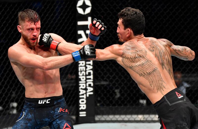 ABU DHABI, UNITED ARAB EMIRATES - JANUARY 17: (R-L) Max Holloway punches Calvin Kattar in a featherweight bout during the UFC Fight Night event at Etihad Arena on UFC Fight Island on January 17, 2021 in Abu Dhabi, United Arab Emirates. (Photo by Jeff Bottari/Zuffa LLC)