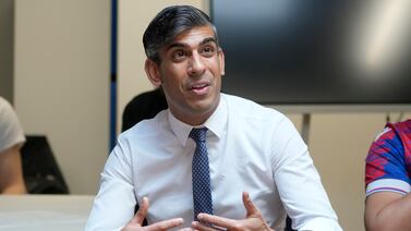 British Prime Minister Rishi Sunak speaks with volunteers during a visit to Palace for Life, a non-profit organisation in south London. PA