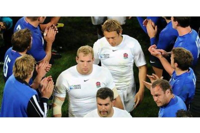 England's disappointed players leave the field after their quarter-final defeat to France on Saturday.