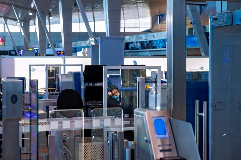 A transportation security administration agent sits at a checkpoint at Ben Gurion Airport, Israel's main international hub, as it stands empty after the government approved a shutdown of all incoming and outgoing air traffic for a week. AP
