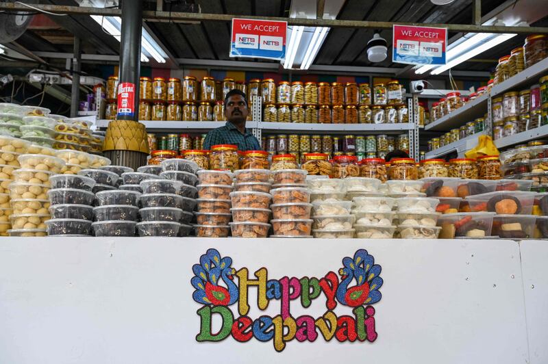 A vendor waits for customers selling cookies in Little India in Singapore. AFP