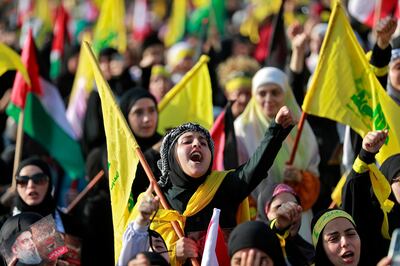 Hezbollah supporters wave Palestine and Hezbollah flags as they watch a televised speech by leader Hassan Nasrallah in Beirut. AFP