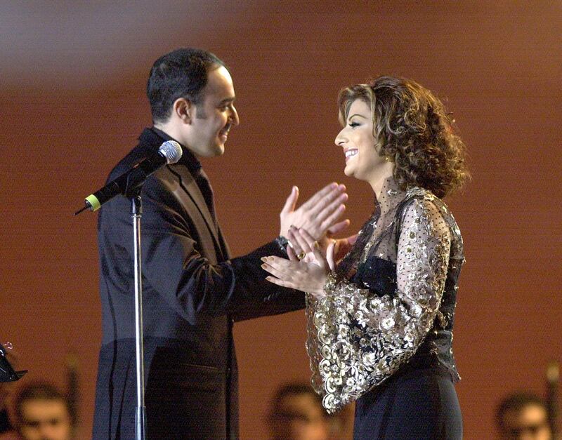 Syrian singer Assalah and Tunisian singer Saber al-Robai after performing a duet during the 7th Dubai Shopping Festival, March 14, 2002. AFP