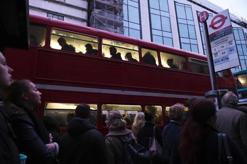 Commuters wait to board a bus at a bus stop near to Victoria station in central London on January 9, 2017 as industrial action halted the vast majority of services on the London underground tube network.  Justin Tallis/AFP

