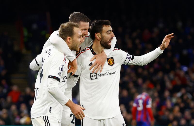 Bruno Fernandes celebrates scoring United's goal with Christian Eriksen and Wout Weghorst. Action Images