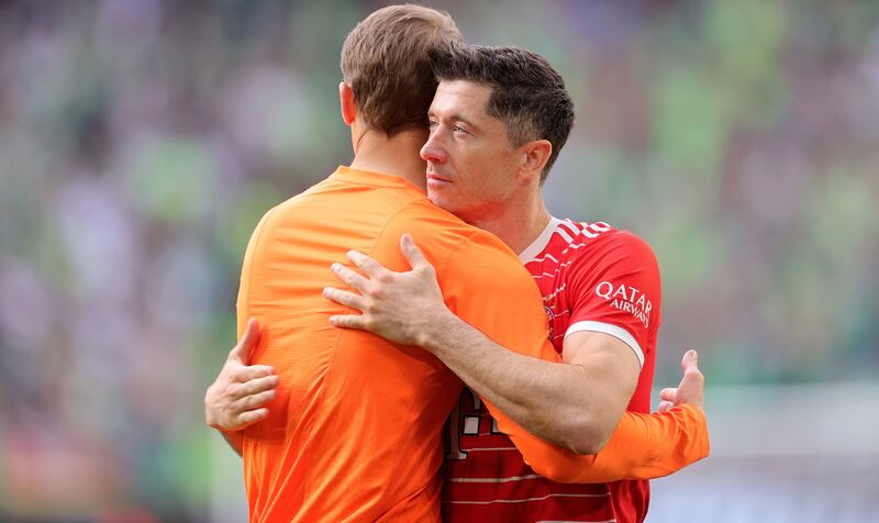 Lewandowski embraces goalkeeper Manuel Neuer. EPA