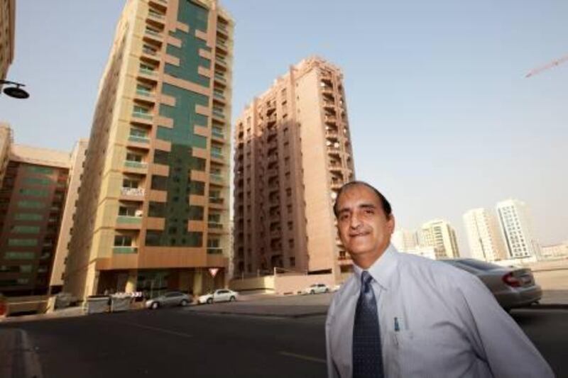 UAE - Dubai - Jun 30- 2011:  Aijaz in front of his building (yellow) at the Nahda area. He has been unfairly overcharged on housing fees.  ( Jaime Puebla - The National Newspaper )