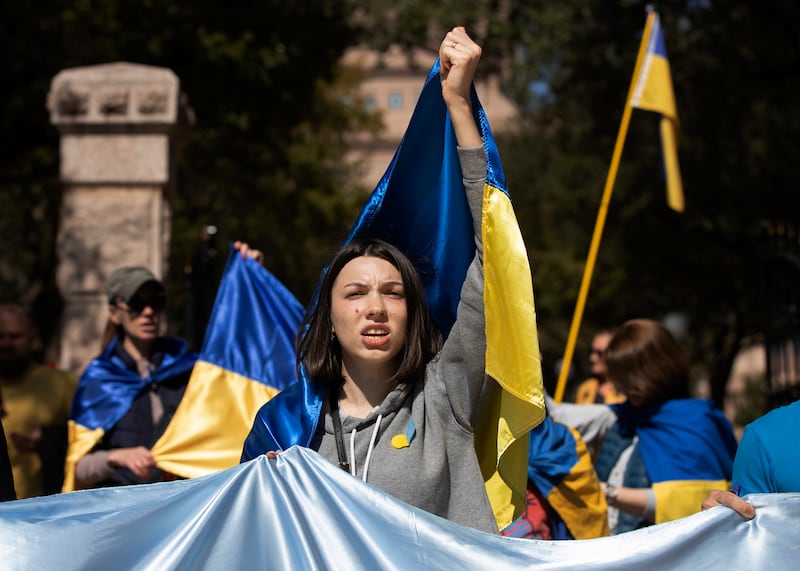 Kristina Ulyanenko protests the Russian attack on Ukraine at the state capitol in Austin, Texas. AP