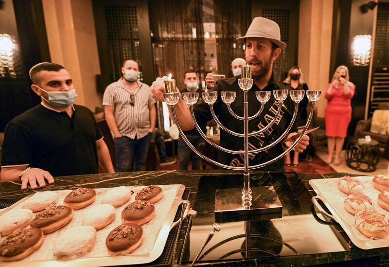 Israeli businessman Gil Gurevitch chants religious hymns as he lights a Hanukkah menorah at a hotel in Dubai. AFP