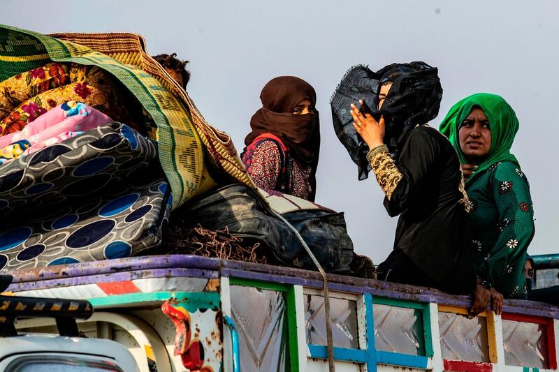 Syrians flee with their belongings.  AFP