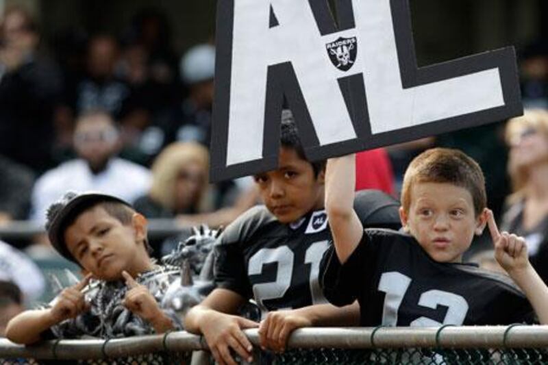 Young supporters of the Oakland Raiders show their affection for the late owner, Al Davis.