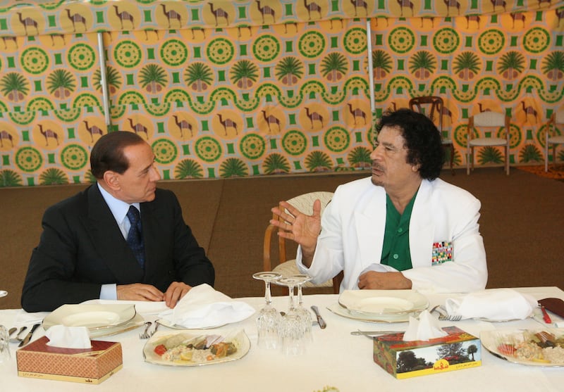 Former Libyan leader Muammar Qaddafi meets Mr Berlusconi in a tent in Sirte in June 2008. Mr Berlusconi was seeking a deal to stop thousands of illegal immigrants from reaching Italian shores. AFP