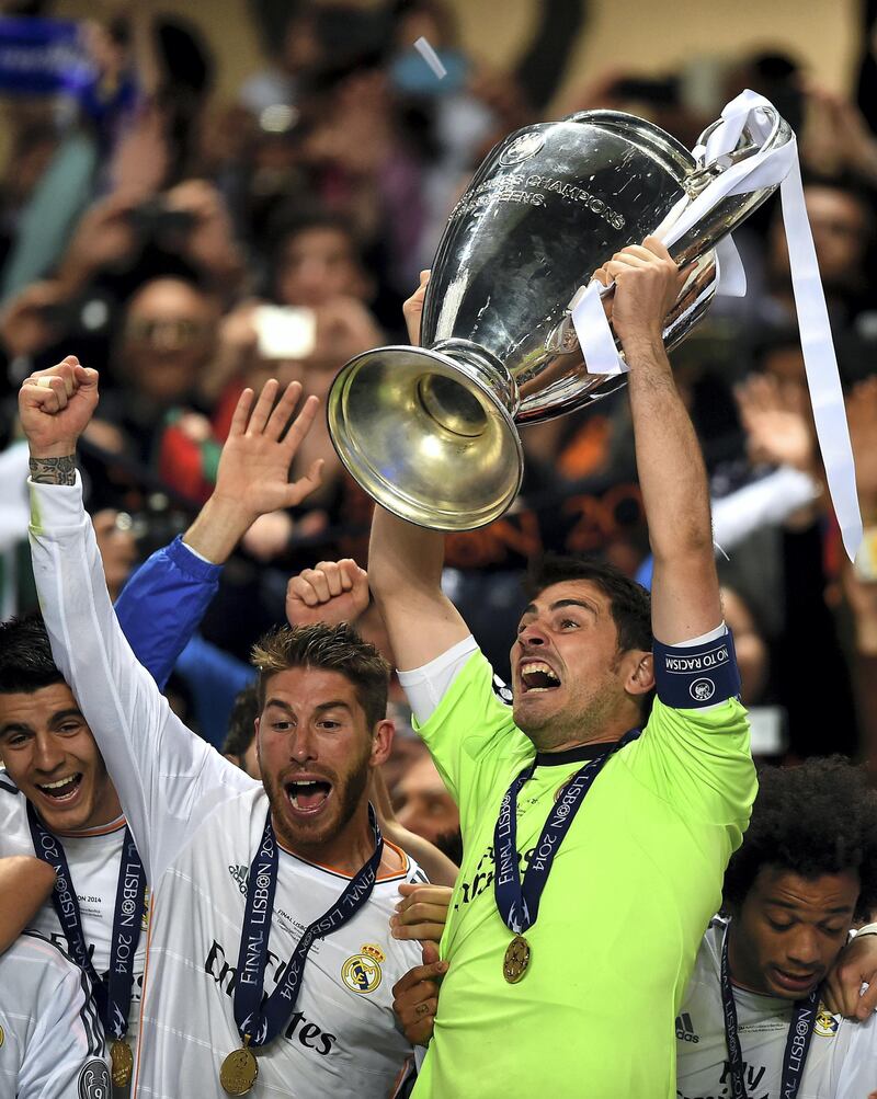 LISBON, PORTUGAL - MAY 24:  Iker Casillas of Real Madrid lifts the Champions League trophy as Sergio Ramos of Real Madrid (L) celebrates during the UEFA Champions League Final between Real Madrid and Atletico de Madrid at Estadio da Luz on May 24, 2014 in Lisbon, Portugal.  (Photo by Laurence Griffiths/Getty Images)