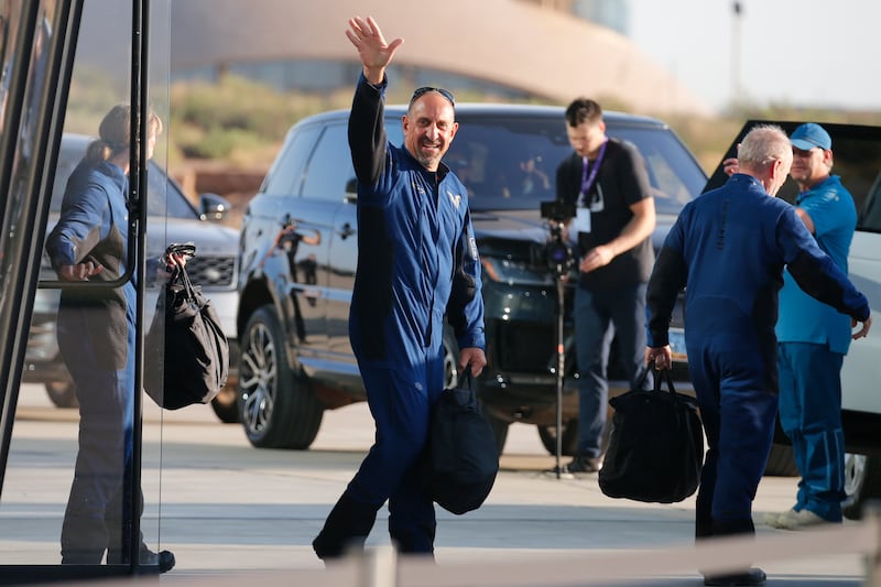 Pilot Michael Masucci makes his way to Virgin Galactic's passenger rocket plane 'VSS Unity'.