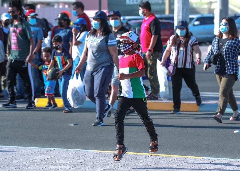 Abu Dhabi, United Arab Emirates, December, 2, 2020.A boy crosses the street to watch the Al Fursan Airshow which got cancelled.
Victor Besa/The National
Section:  National News