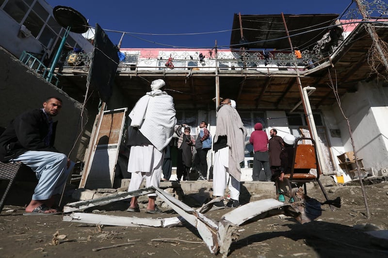 Afghan men gather at the site of a rocket attack at a residential house in Kabul, Afghanistan December 12, 2020. EPA
