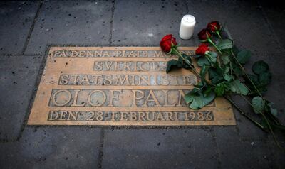 FILE PHOTO: Roses are laid on a plaque marking the location where Swedish Prime Minister Olof Palme was shot and killed 25 years ago on a street in Stockholm February 28, 2011. The plaque reads "In this place Sweden's Prime Minister Olof Palme was murdered on February 28, 1986."   REUTERS/Bob Strong/File Photo