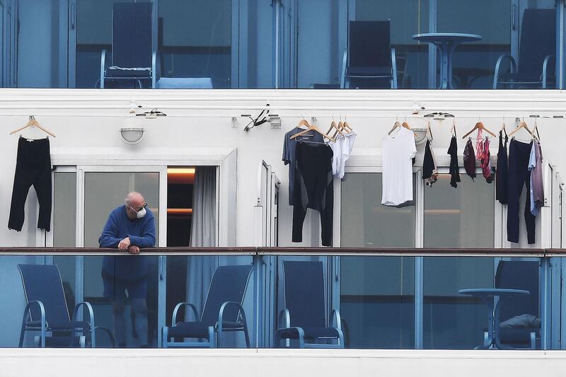 A passengers is seen on a balcony of the Diamond Princess cruise ship at the Daikoku Pier Cruise Terminal in Yokohama, Japan. AFP