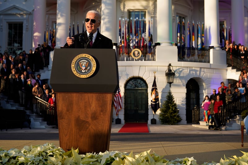 Mr Biden addresses people packed on to the South Lawn of the White House. AP