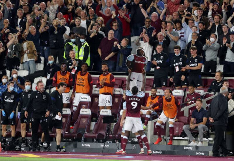 Michail Antonio celebrates with a cardboard cut-out of himself after becoming West Ham United's record Premier League goalscorer during the Hammers' 4-1 win over Leicester City at the London Stadium on Monday, August 23. Getty