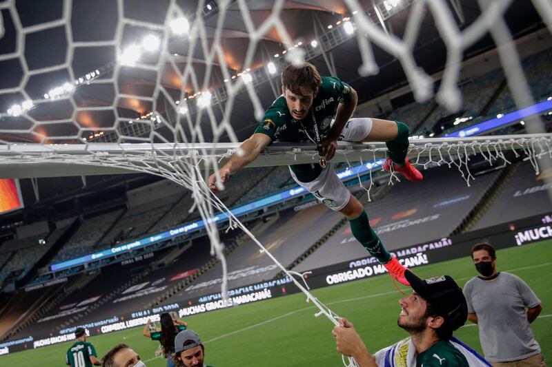 Palmeiras player Matias Vina cuts the goal net as he celebrates winning the Copa Libertadores football tournament after defeating Santos 1-0 at the Maracana Stadium, in Rio de Janeiro, on Saturday, January 30. AFP