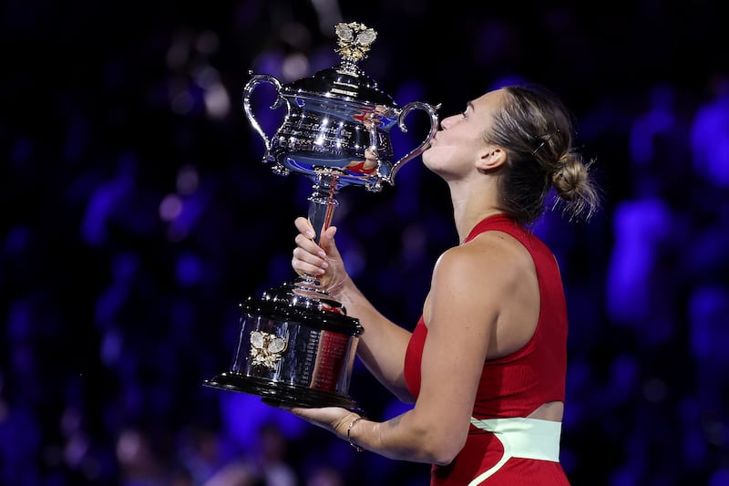 Aryna Sabalenka poses with the Daphne Akhurst Memorial Cup after beating Qinwen Zheng 6-3, 6-2. Getty Images