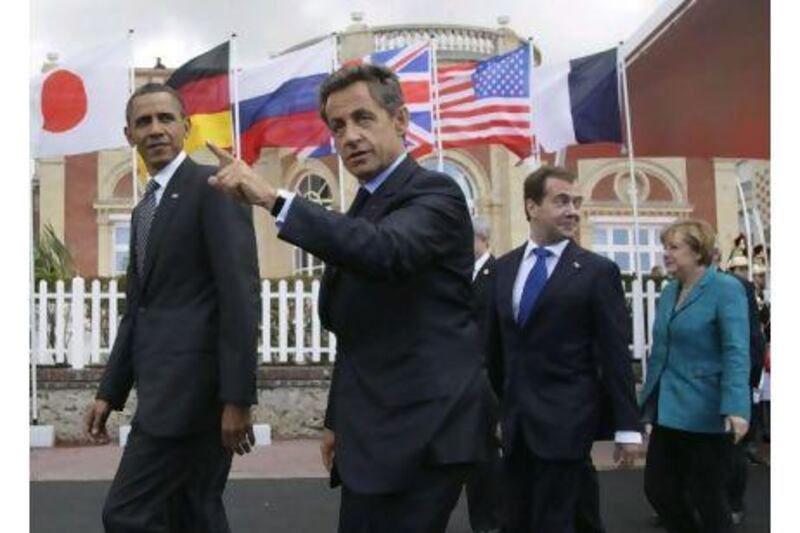 From left, President Barack Obama, French President Nicolas Sarkozy, Russian President Dmitry Medvedev, and German Chancellor Angela Merkel, walk together to the first plenary session at the G8 Summit, in Deauville, France, yesterday.