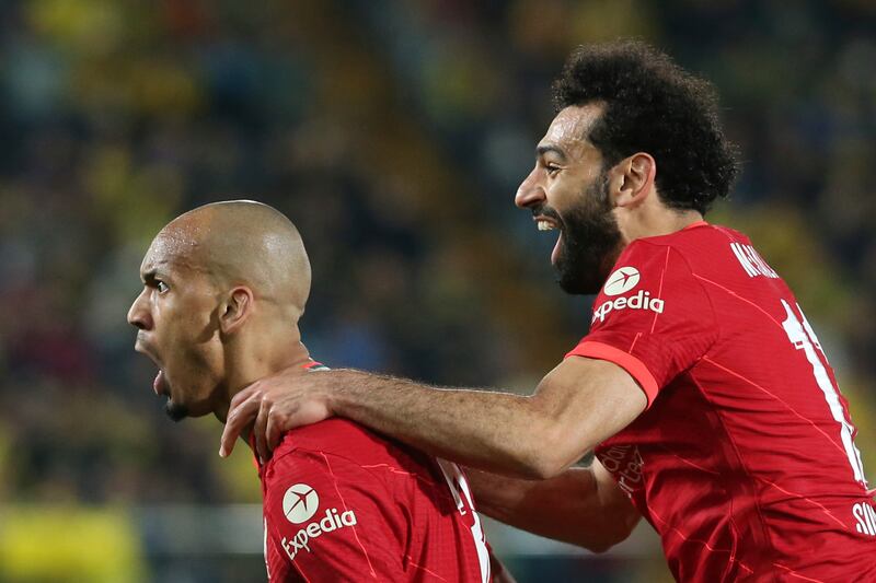 Fabinho celebrates with Mohamed Salah. AP