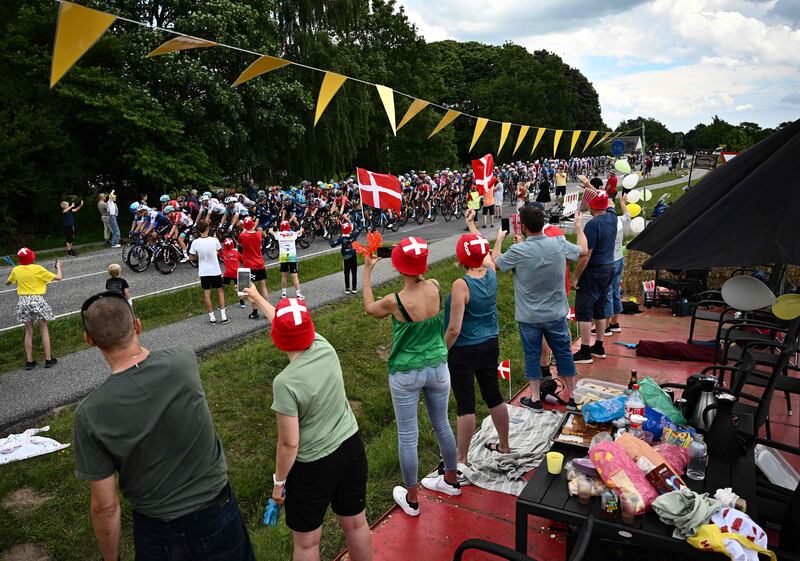 Spectators cheer as the peloton passes during Stage 3. AFP