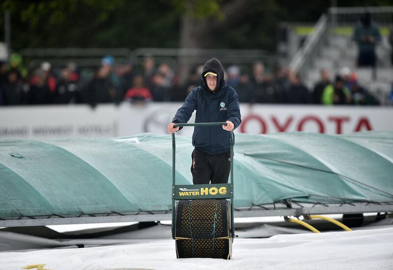 A groundsman at work in the rain as Ireland prepare to play their first ever cricket Test against Pakistan on Friday. Charles McQuillan / Getty Images