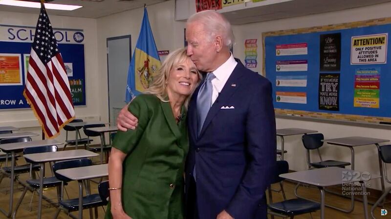 U.S. Democratic presidential candidate Joe Biden kisses his wife Jill Biden on the forehead at Brandywine High School, where she taught English from 1991 to 1993, during the virtual 2020 Democratic National Convention.  REUTERS