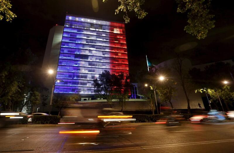 The senate building in Mexico City is lit up in blue, white and red, the colours of the French flag. Tomas Bravo/Reuters