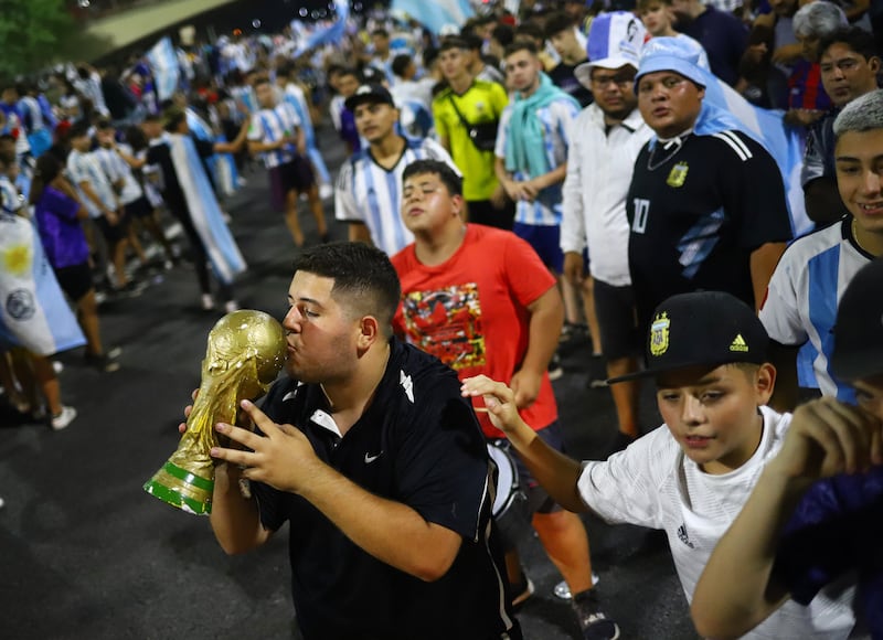 Fans gather outside of the Association of Argentinian Football Headquarters ahead of the team arrival. Reuters