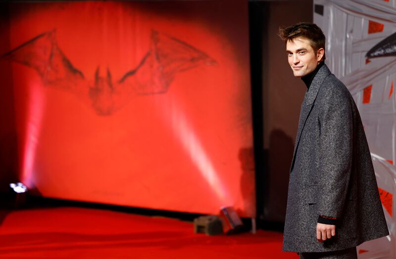 Robert Pattinson poses on the red carpet upon arrival. AFP