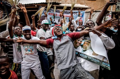 TOPSHOT - People celebrate on February 27, 2019 in a street of Kano, the re-election of Muhammadu Buhari as Nigerian president after a delayed poll that angered voters and raised political temperatures - but the opposition immediately vowed to challenge the "sham" result in court.  / AFP / Luis TATO
