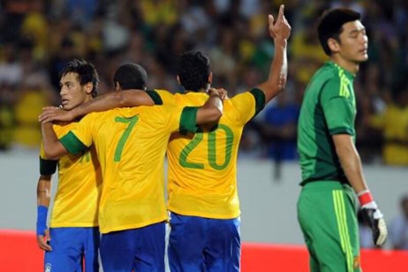 Brazil star Neymar celebrates with teammates after scoring against China