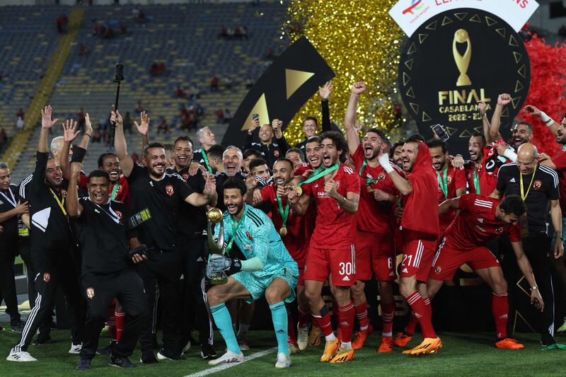 Al Ahly players celebrate with the CAF Champions League trophy. AFP