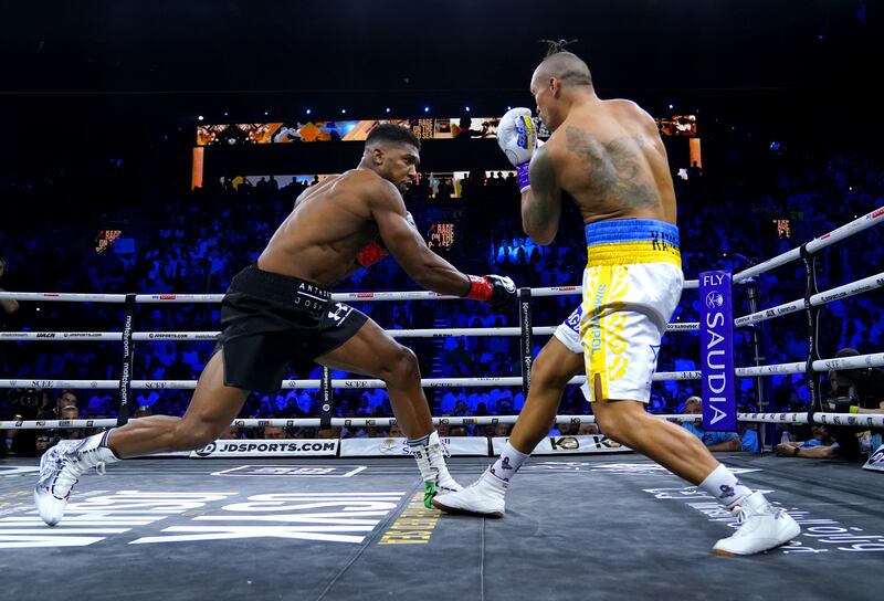 Anthony Joshua and Oleksandr Usyk in action at the King Abdullah Sport City Stadium in Jeddah. PA