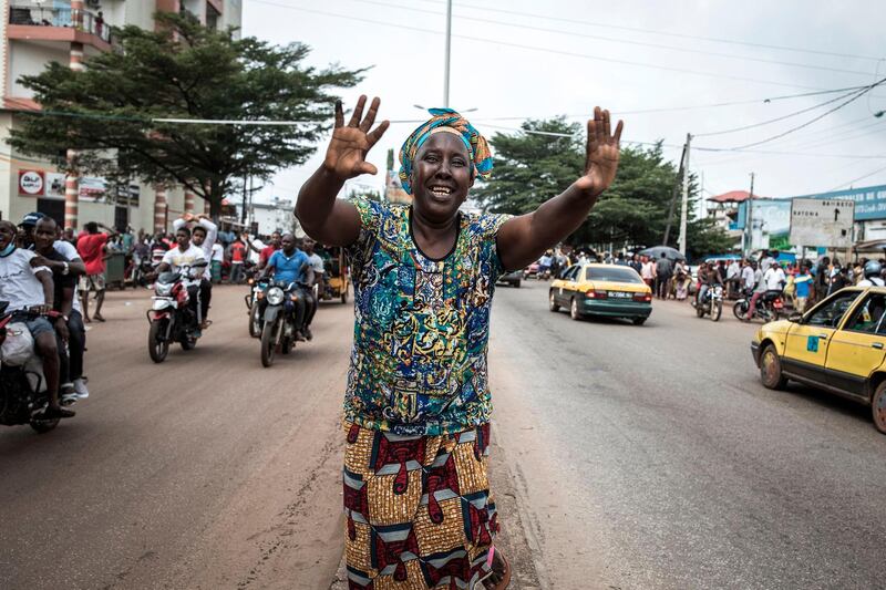 A supporters of Main opposition candidate, Cellou Dalein Diallo celebrates in the street as he declares victory one day after elections in Conakry, Guinea. AFP