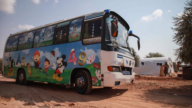 A bus converted into a classroom arrives to a camp in the village of Hazano in northwestern Syria. All photos by AFP