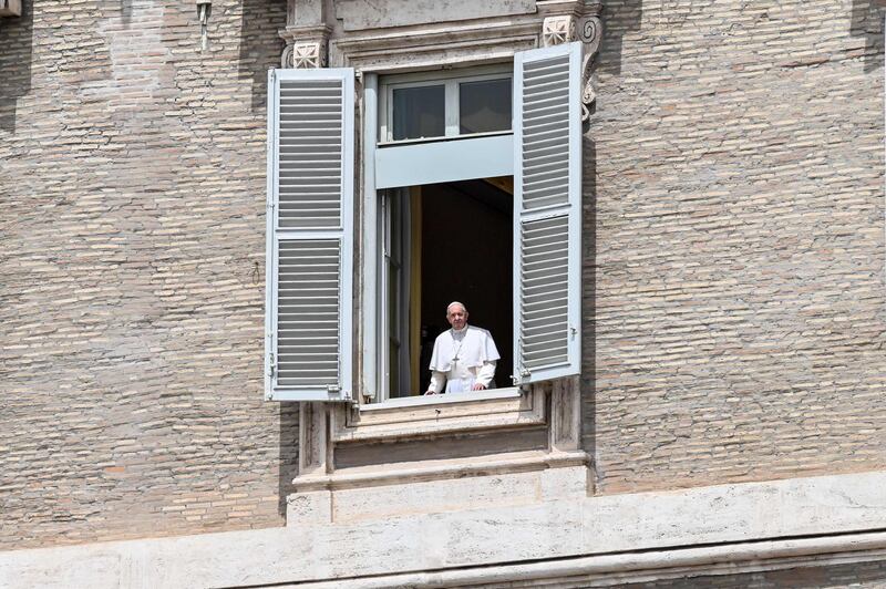 Pope Francis looks from the window of the Apostolic palace overlooking St Peter's Square before his blessing to faithful. AFP