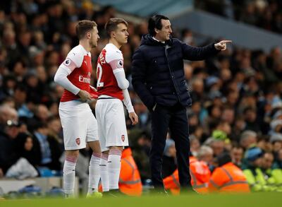 Soccer Football - Premier League - Manchester City v Arsenal - Etihad Stadium, Manchester, Britain - February 3, 2019   Arsenal's Aaron Ramsey and Denis Suarez receive instructions from manager Unai Emery before being substituted on  Action Images via Reuters/Carl Recine    EDITORIAL USE ONLY. No use with unauthorized audio, video, data, fixture lists, club/league logos or "live" services. Online in-match use limited to 75 images, no video emulation. No use in betting, games or single club/league/player publications.  Please contact your account representative for further details.